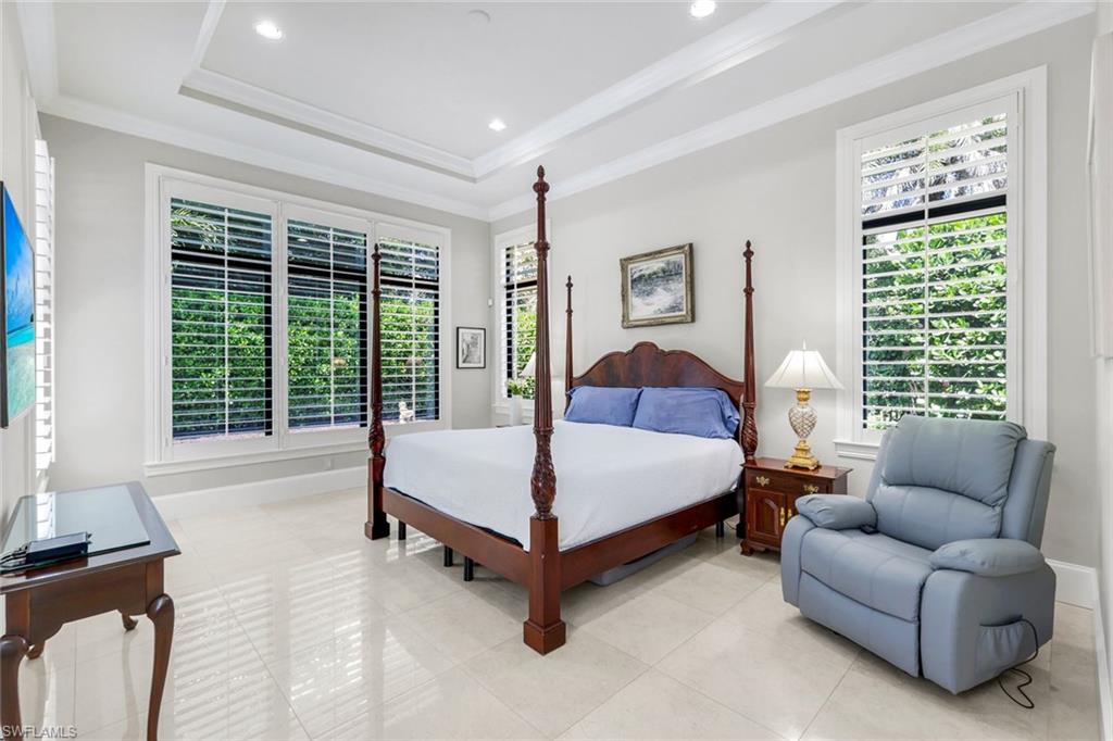 2351 Traditions Court Naples, FL 34105 - Photo 24 of 48 a bedroom with a bed couch and a large window