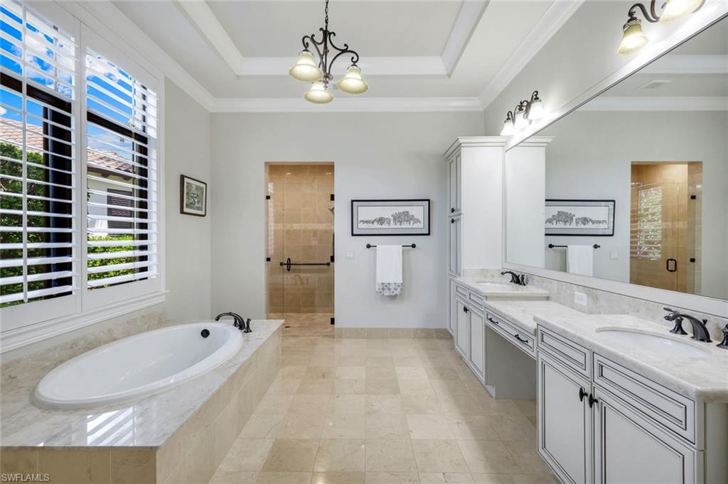 2351 Traditions Court Naples, FL 34105 - Photo 27 of 48 a spacious bathroom with a granite countertop sink a toilet a shower and a mirror