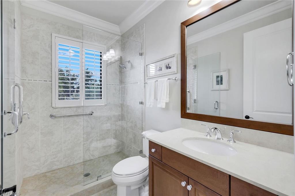 2351 Traditions Court Naples, FL 34105 - Photo 30 of 48 a bathroom with a sink a toilet and shower