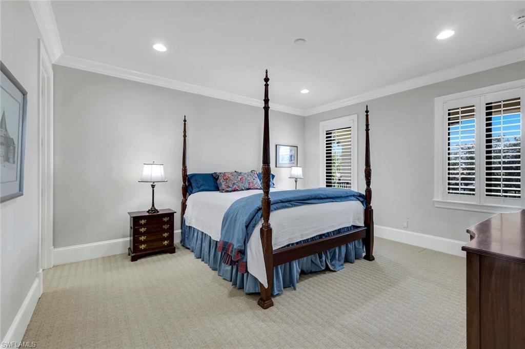 2351 Traditions Court Naples, FL 34105 - Photo 31 of 48 a spacious bedroom with a bed window and a table