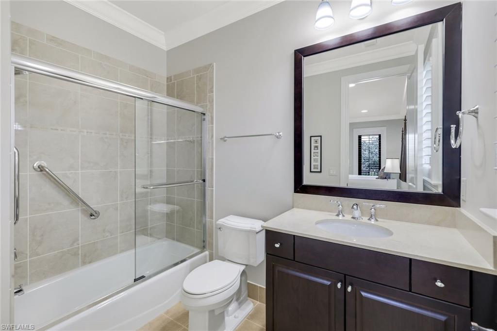 2351 Traditions Court Naples, FL 34105 - Photo 32 of 48 a bathroom with a sink a toilet and shower