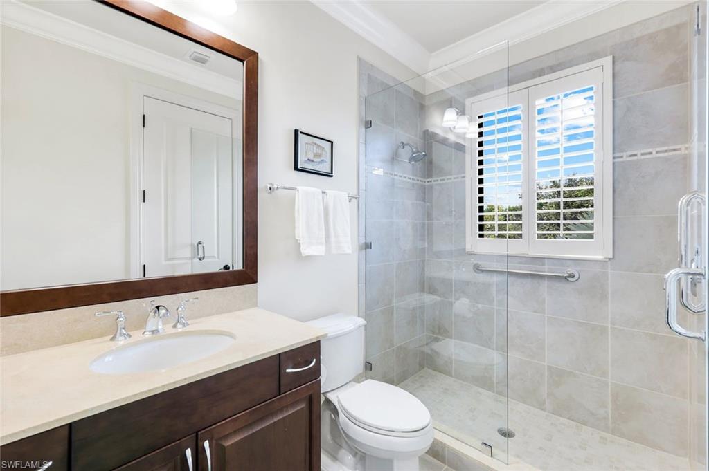 2351 Traditions Court Naples, FL 34105 - Photo 34 of 48 a bathroom with a sink a toilet and shower
