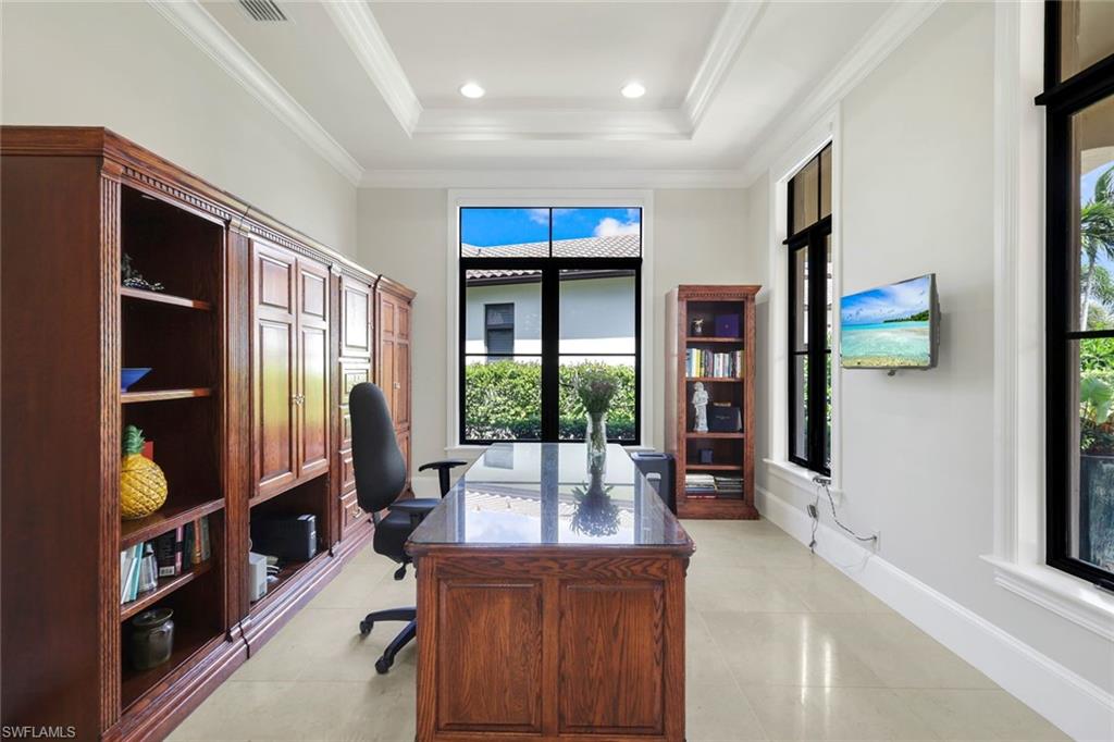 2351 Traditions Court Naples, FL 34105 - Photo 35 of 48 a living room with furniture a flat screen tv and a large window