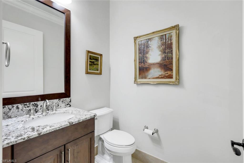 2351 Traditions Court Naples, FL 34105 - Photo 36 of 48 a bathroom with a granite countertop sink and a toilet