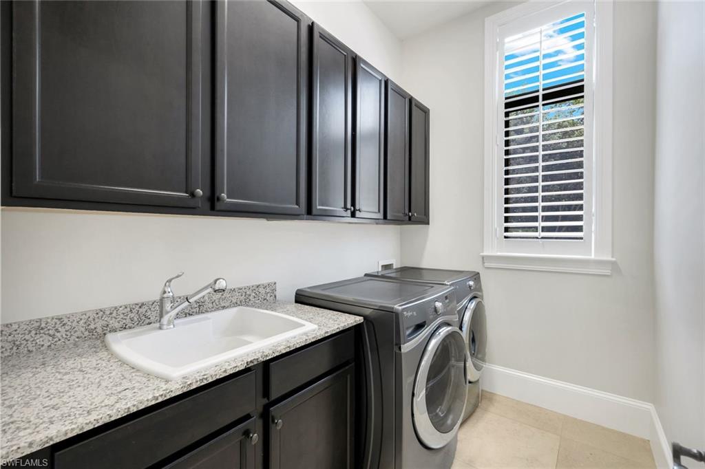 2351 Traditions Court Naples, FL 34105 - Photo 37 of 48 a utility room with granite countertop a sink a washer and dryer