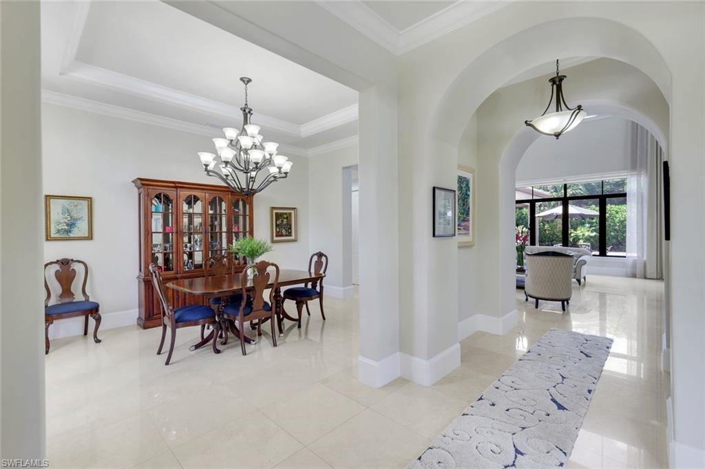 2351 Traditions Court Naples, FL 34105 - Photo 4 of 48 a view of a dining room with furniture and chandelier