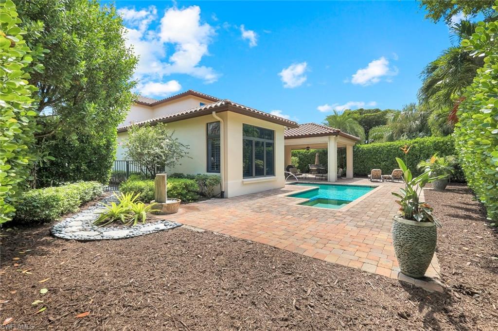 2351 Traditions Court Naples, FL 34105 - Photo 44 of 48 a view of a house with a yard and potted plants