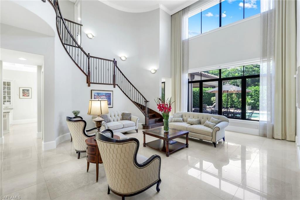 2351 Traditions Court Naples, FL 34105 - Photo 5 of 48 a living room with furniture and floor to ceiling windows