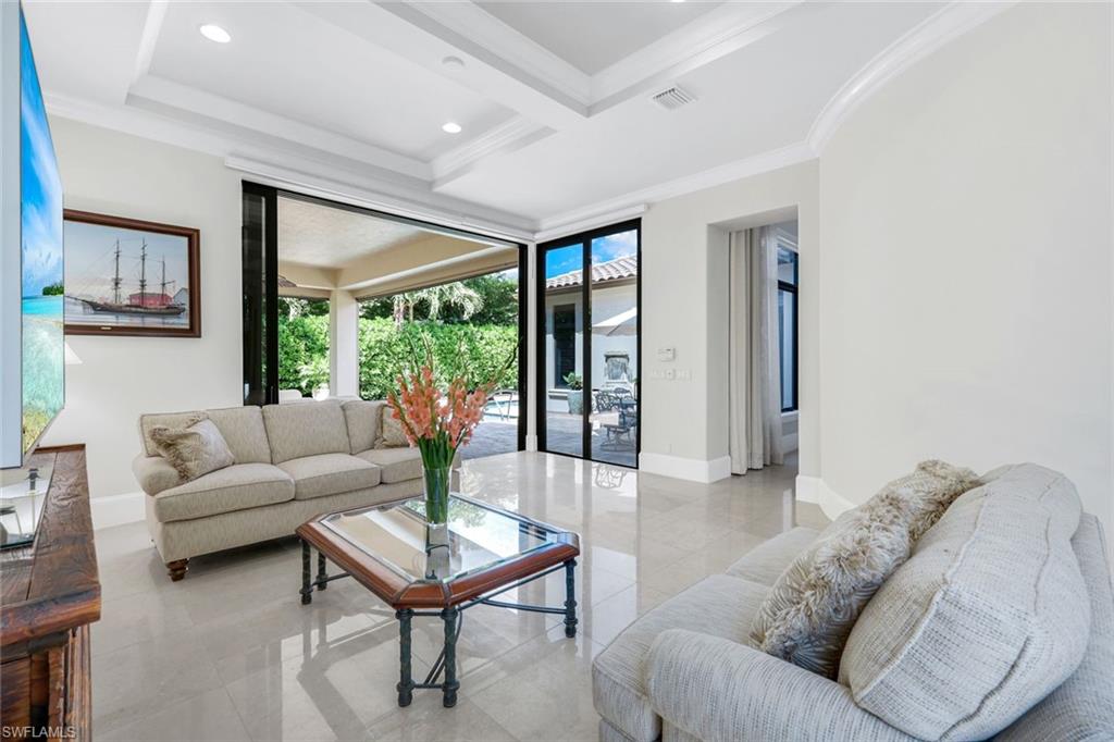 2351 Traditions Court Naples, FL 34105 - Photo 8 of 48 a living room with furniture and a large window