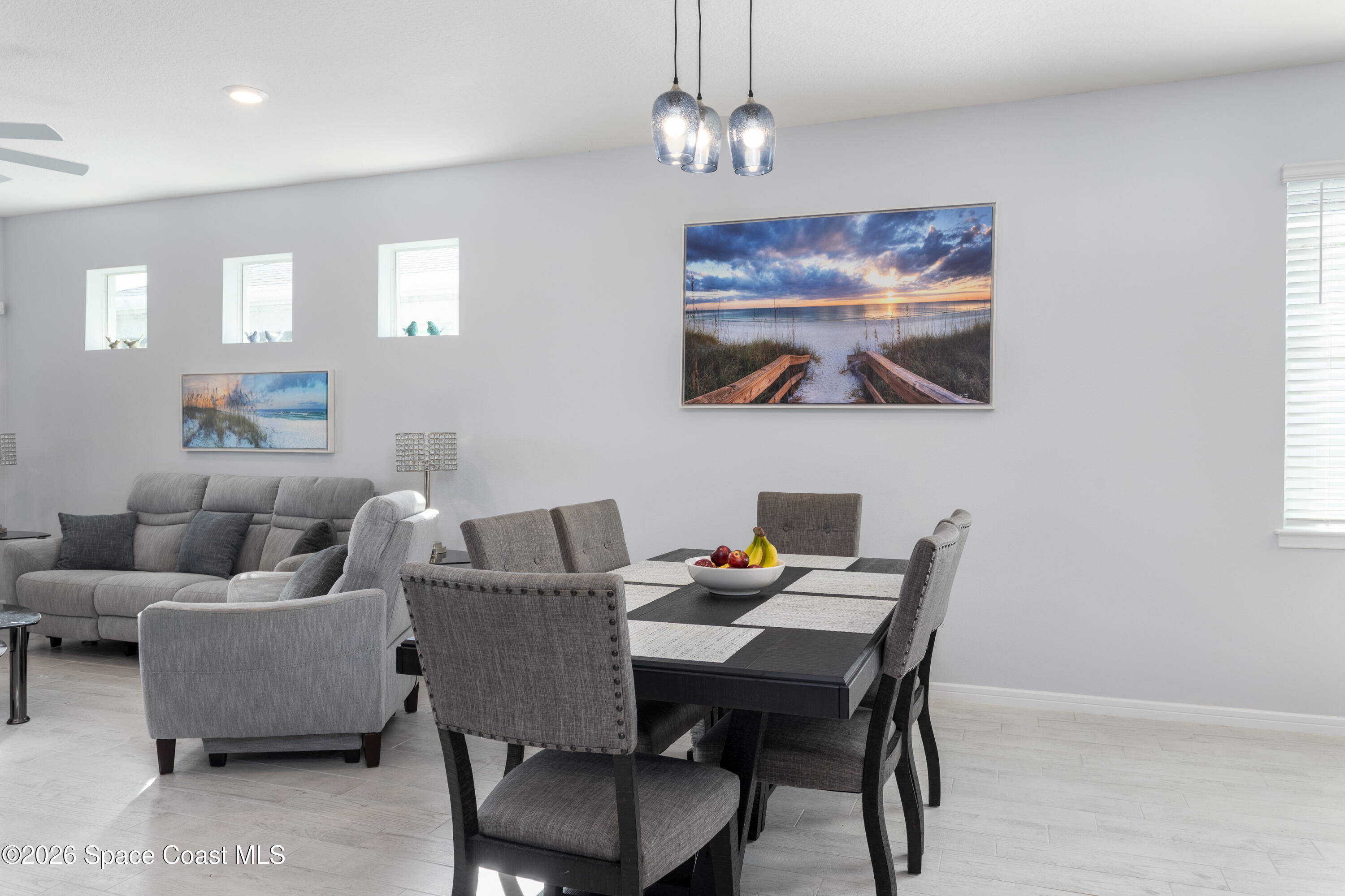2993 Tidepool Place Melbourne, FL 32940 - Photo 12 of 50 a view of a dining room with furniture a chandelier and wooden floor