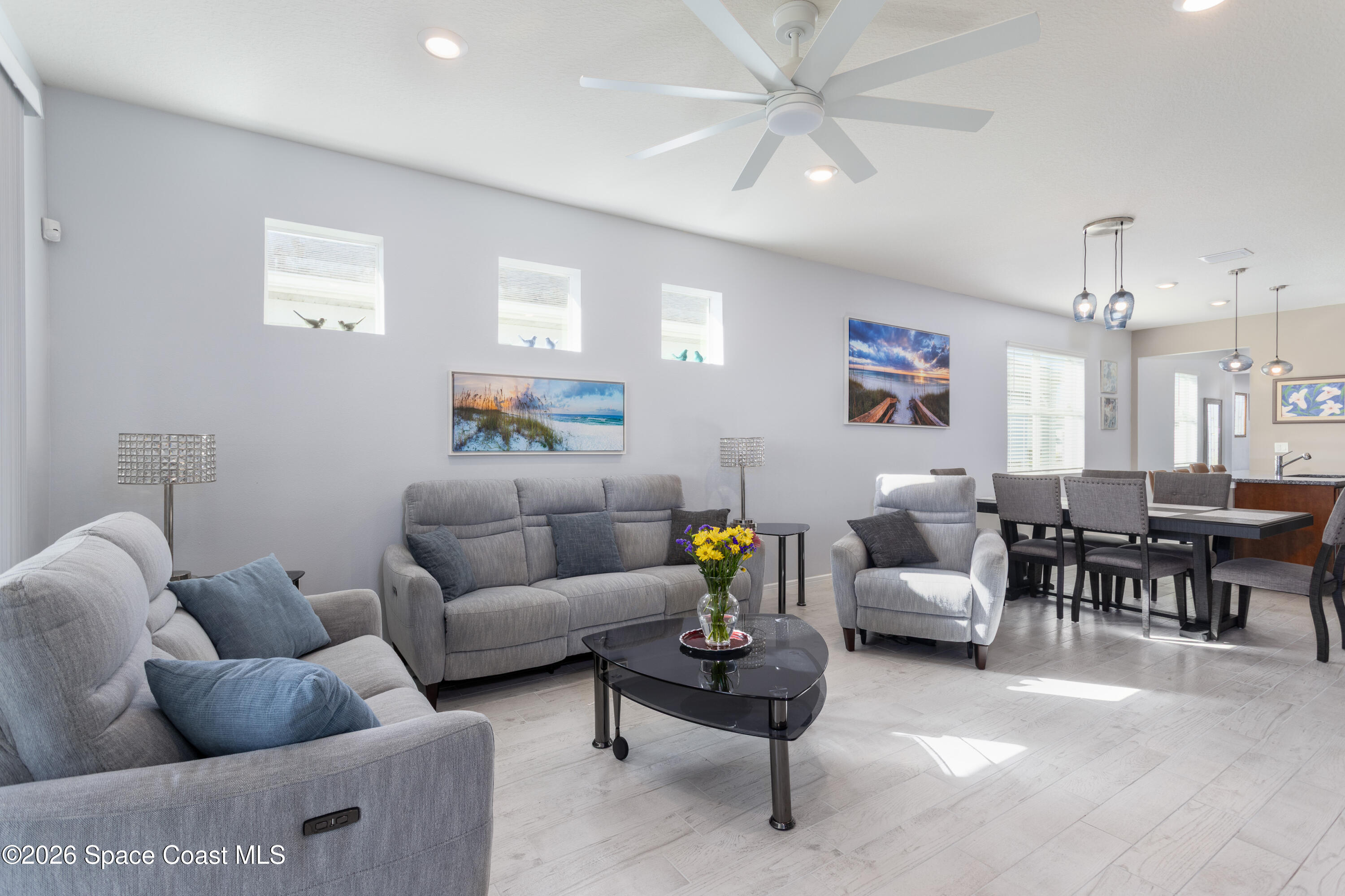 2993 Tidepool Place Melbourne, FL 32940 - Photo 13 of 50 a living room with furniture and a chandelier