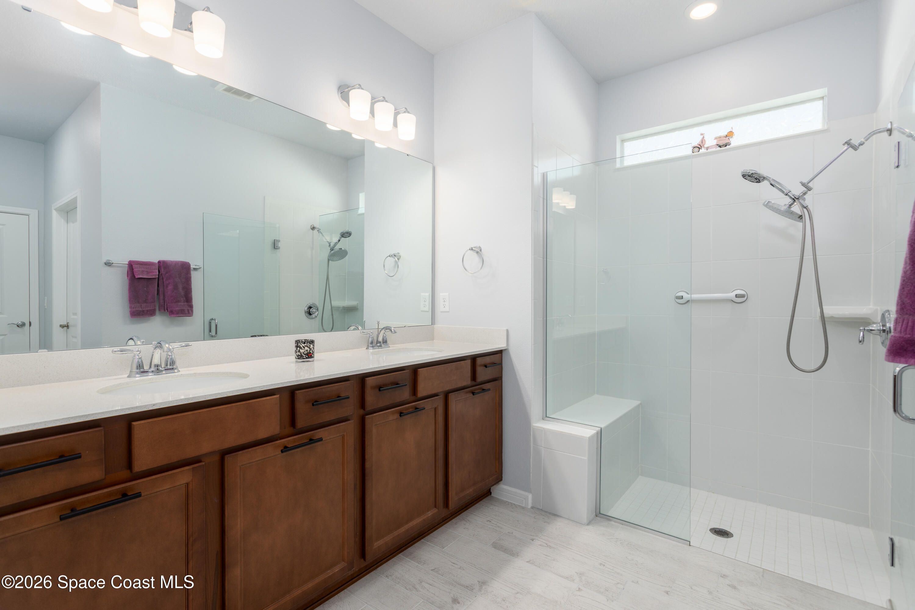 2993 Tidepool Place Melbourne, FL 32940 - Photo 20 of 50 a bathroom with a double vanity sink toilet and shower