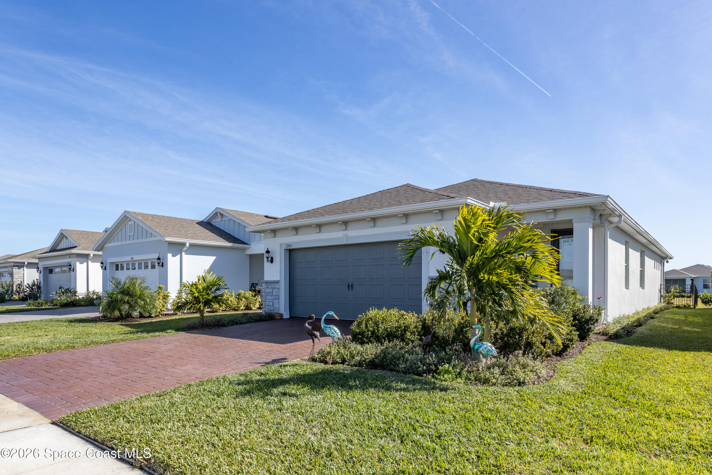 2993 Tidepool Place Melbourne, FL 32940 - Photo 2 of 50 a front view of a house with a yard and potted plants
