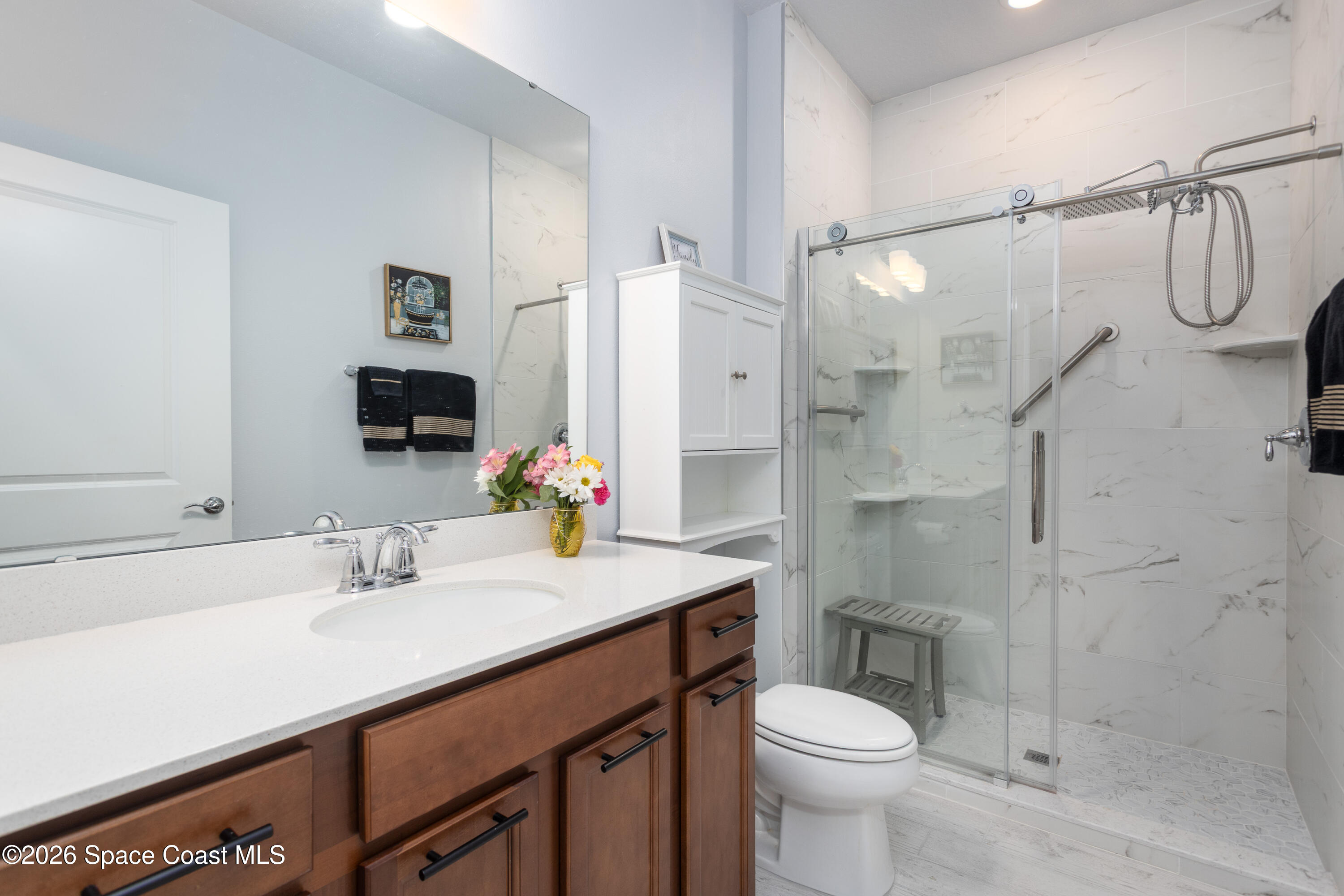 2993 Tidepool Place Melbourne, FL 32940 - Photo 24 of 50 a bathroom with a sink toilet and shower