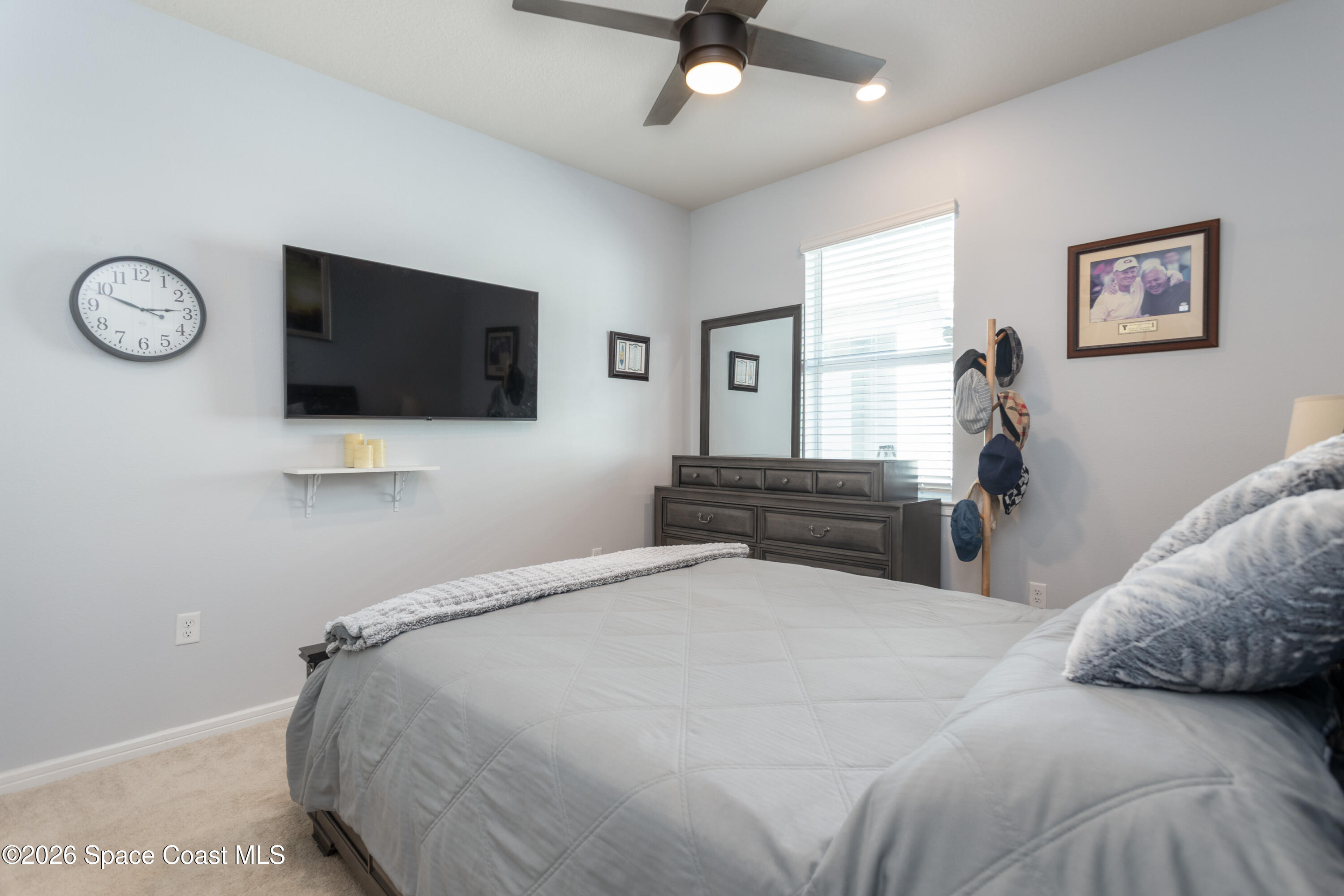 2993 Tidepool Place Melbourne, FL 32940 - Photo 25 of 50 a bedroom with a bed and a flat screen tv