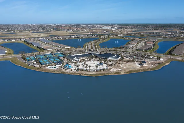 an aerial view of a residential building with an ocean view