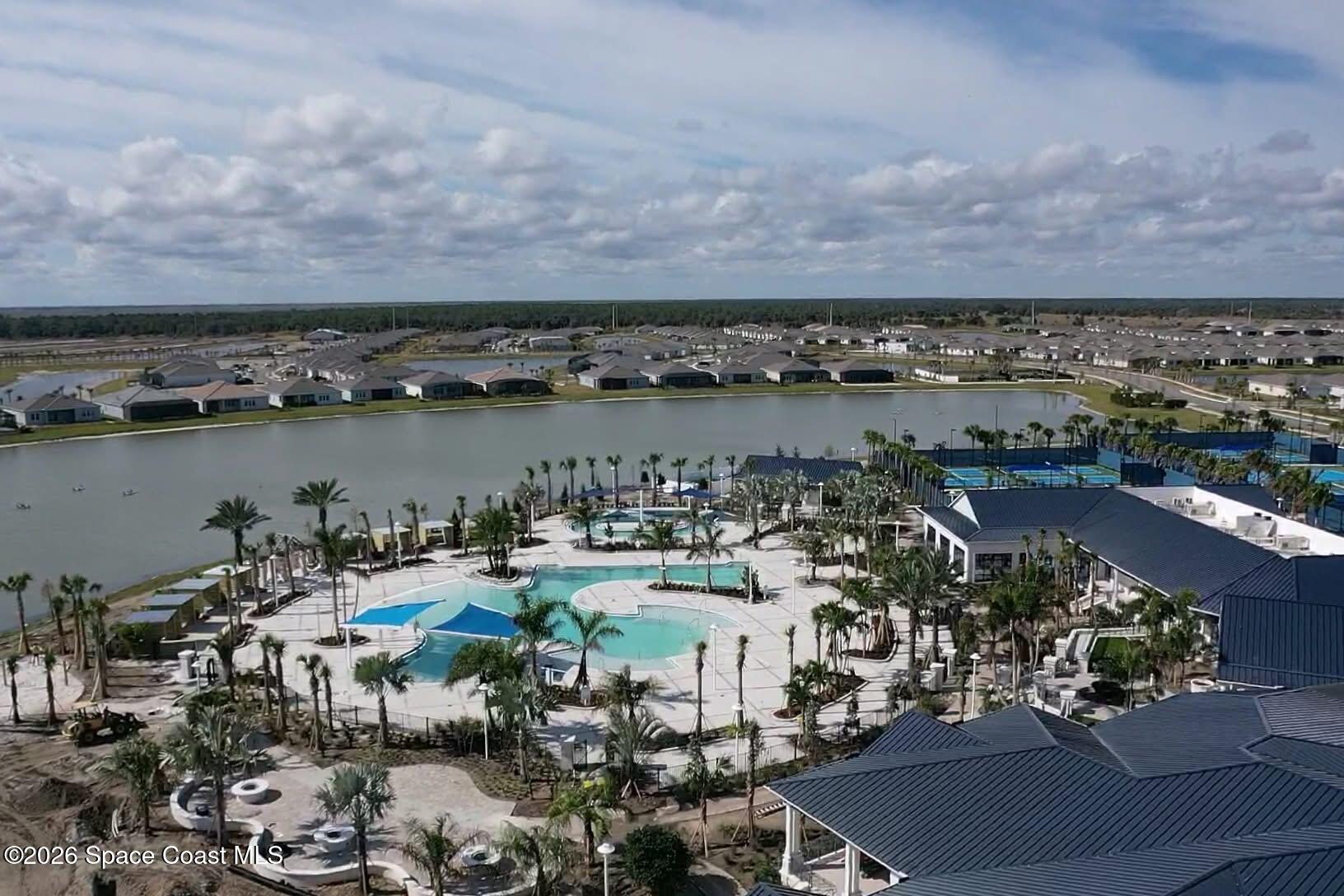 2993 Tidepool Place Melbourne, FL 32940 - Photo 46 of 50 an aerial view of a city with lots of residential buildings lake and ocean view