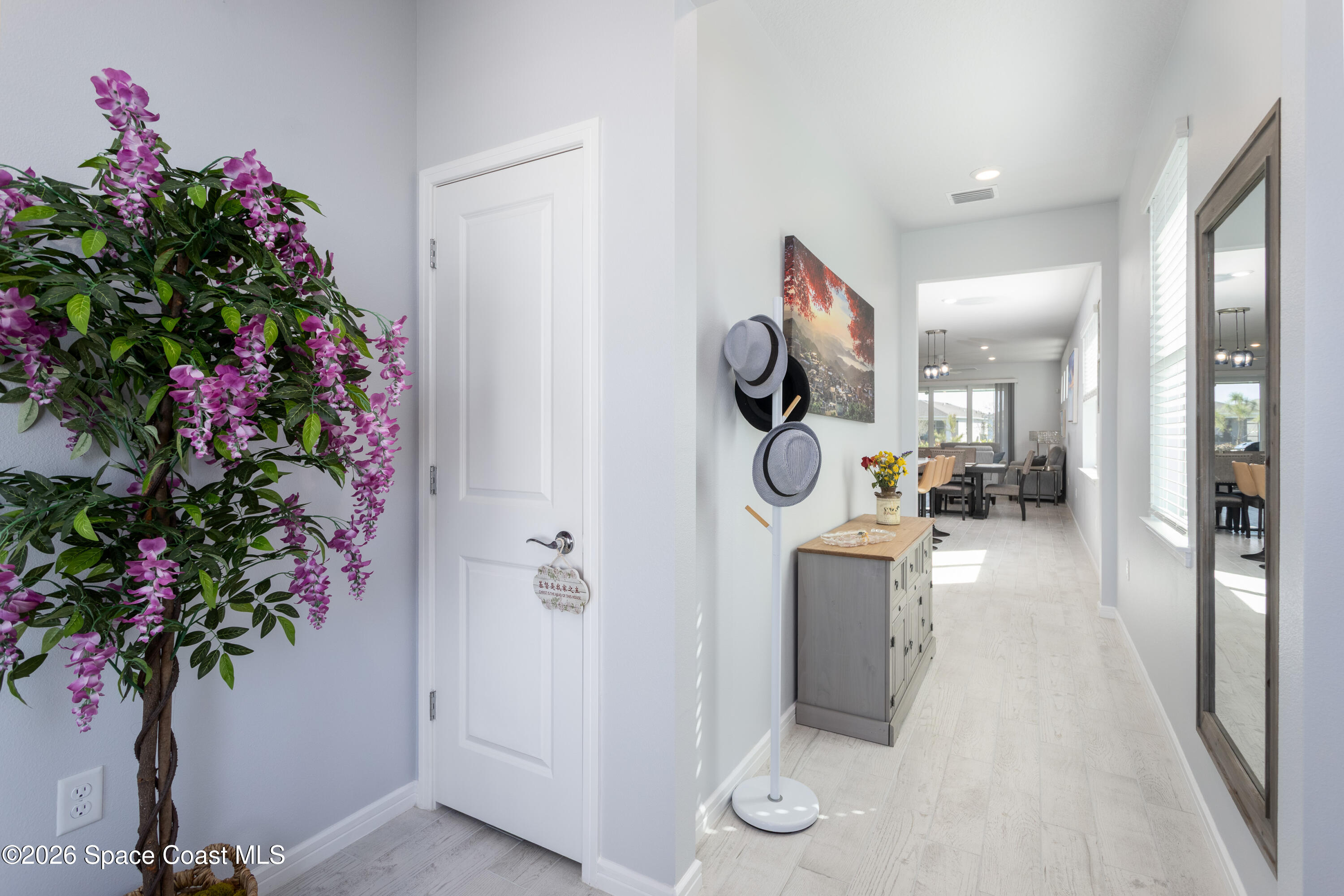 2993 Tidepool Place Melbourne, FL 32940 - Photo 6 of 50 a hallway with a potted plant and a table