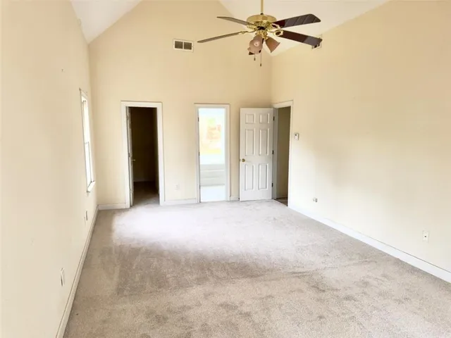 a view of a room with a ceiling fan