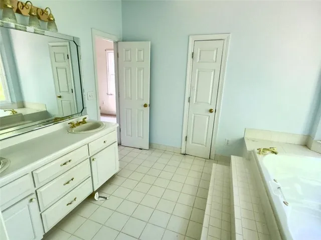 a spacious bathroom with a double vanity sink mirror and