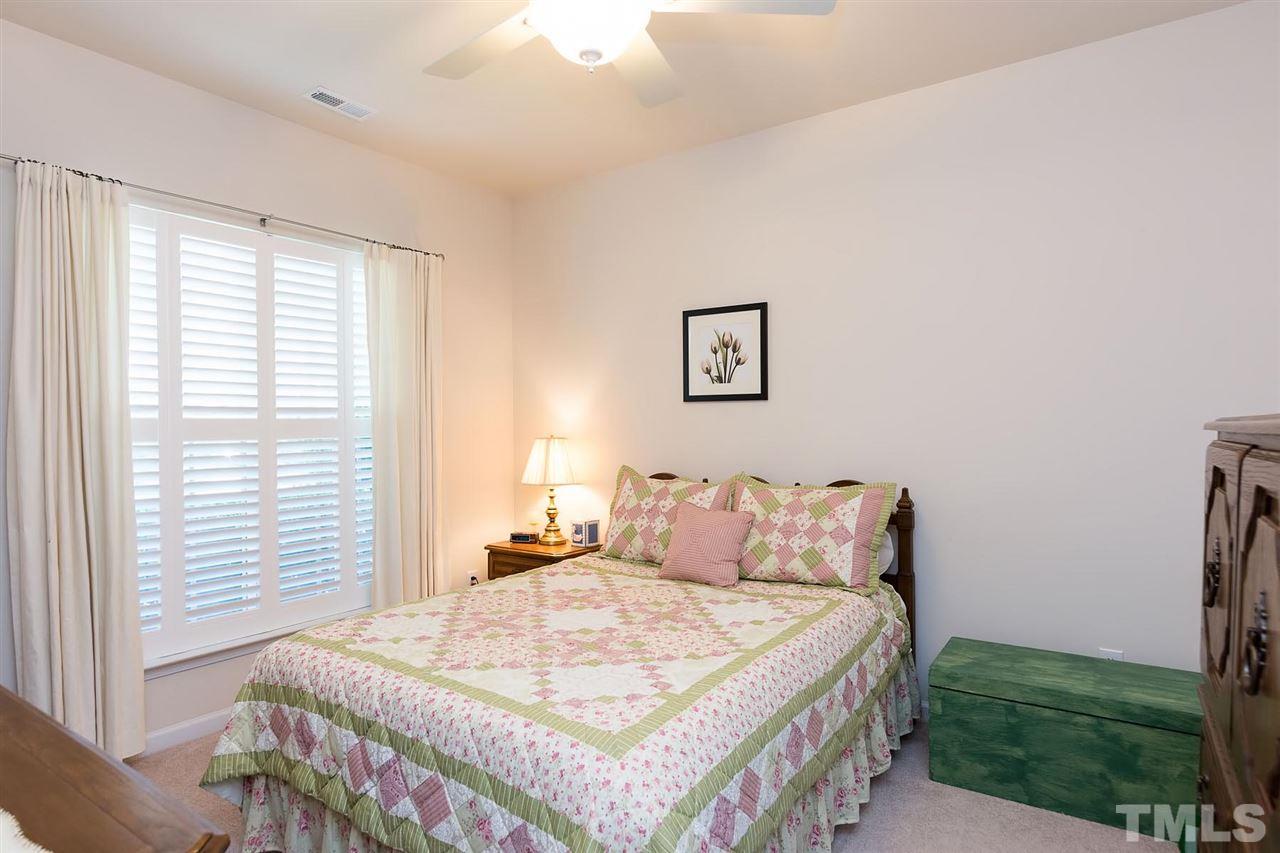 3413 Secretariat Way Raleigh, NC 27614 - Photo 12 of 23 a bedroom with a bed and a large window