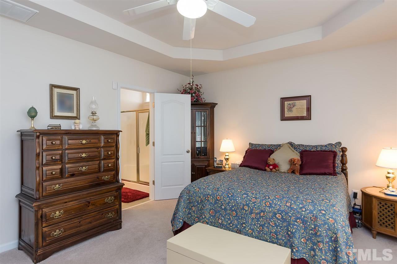 3413 Secretariat Way Raleigh, NC 27614 - Photo 15 of 23 a bedroom with a bed and a dresser
