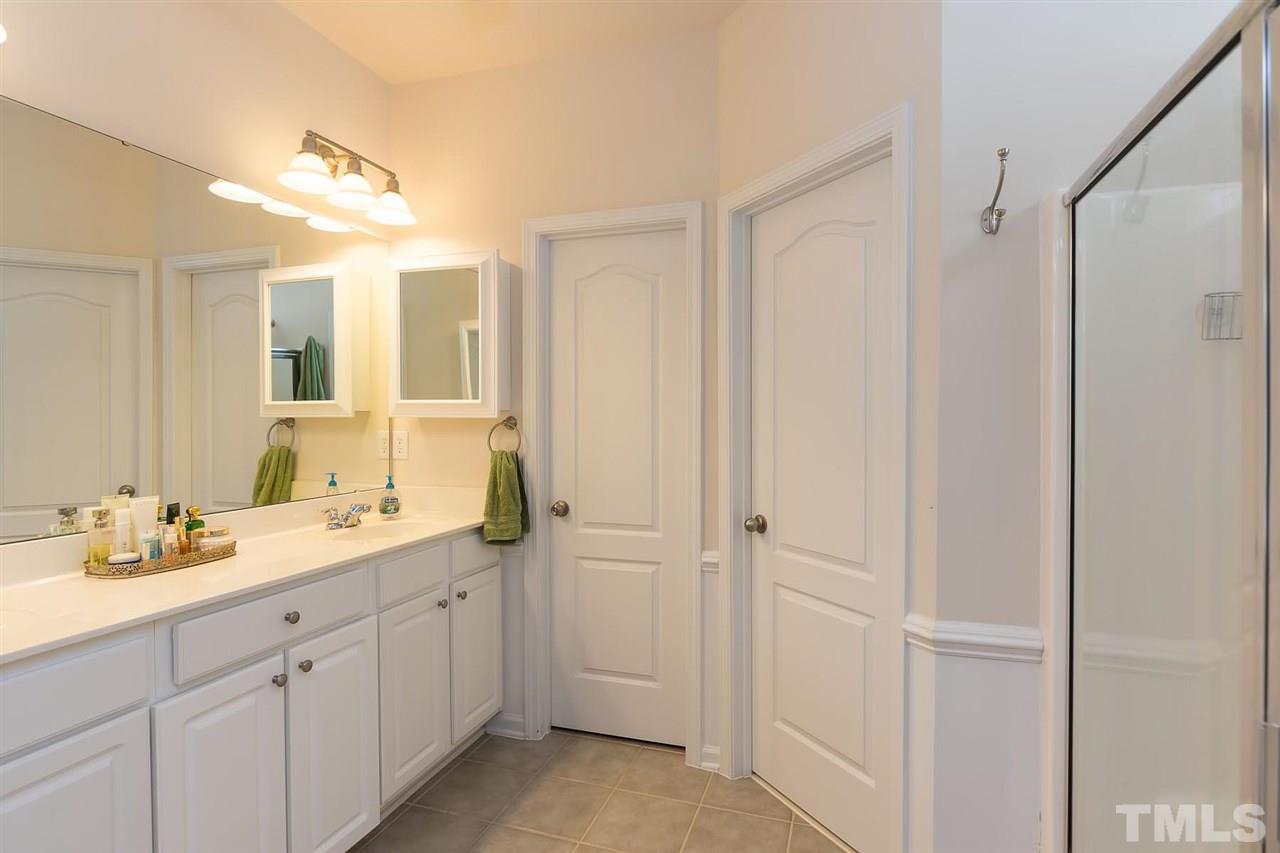 3413 Secretariat Way Raleigh, NC 27614 - Photo 16 of 23 a spacious bathroom with a double vanity sink a mirror and a shower