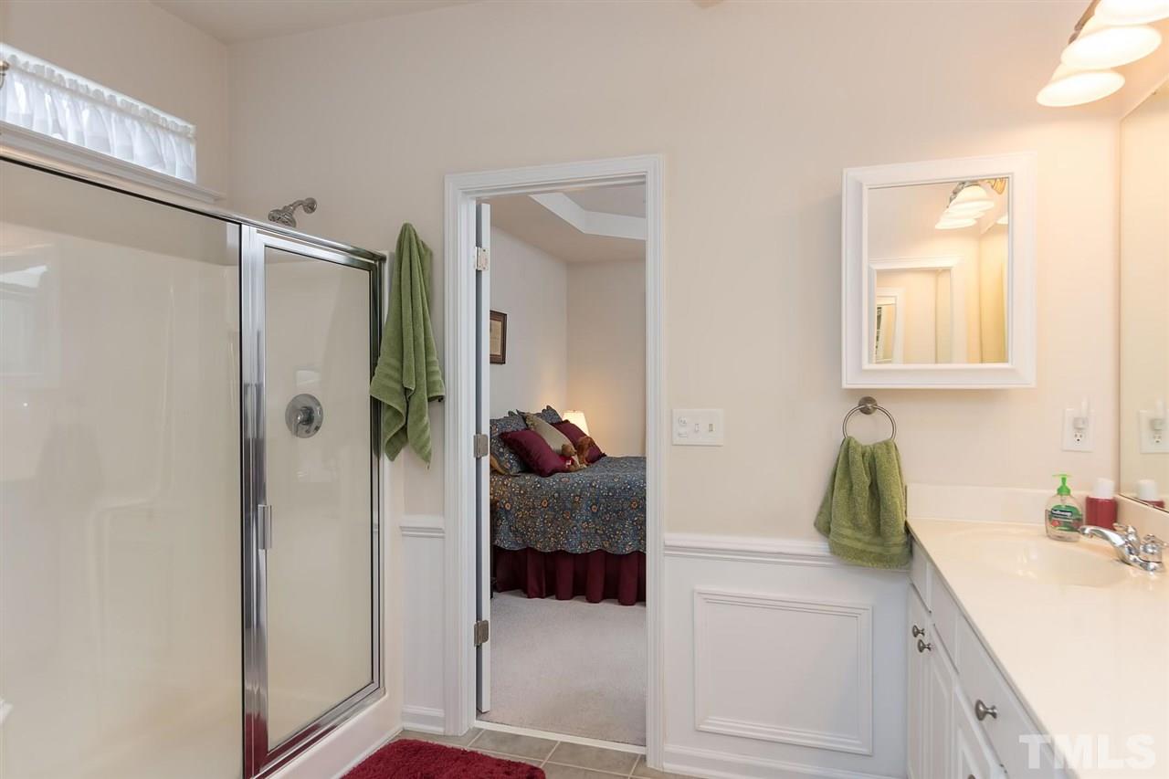 3413 Secretariat Way Raleigh, NC 27614 - Photo 17 of 23 a en suite bathroom with a sink and mirror