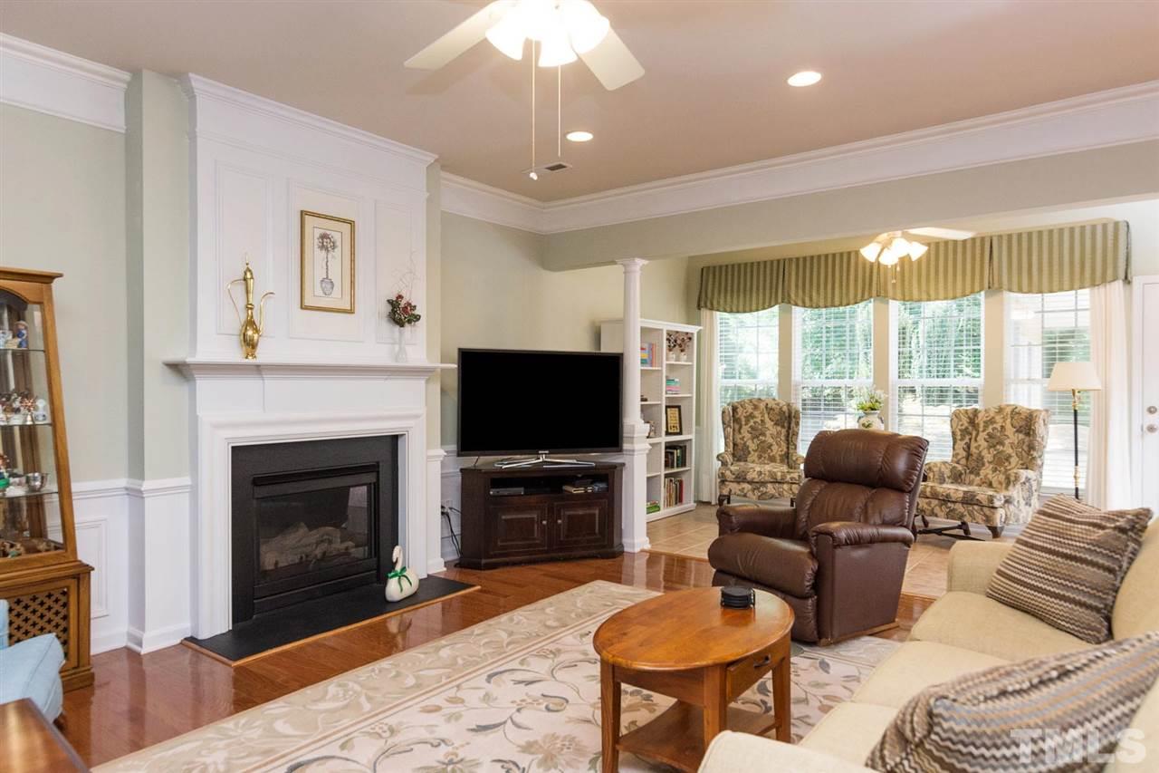 3413 Secretariat Way Raleigh, NC 27614 - Photo 3 of 23 a living room with furniture a fireplace and a flat screen tv