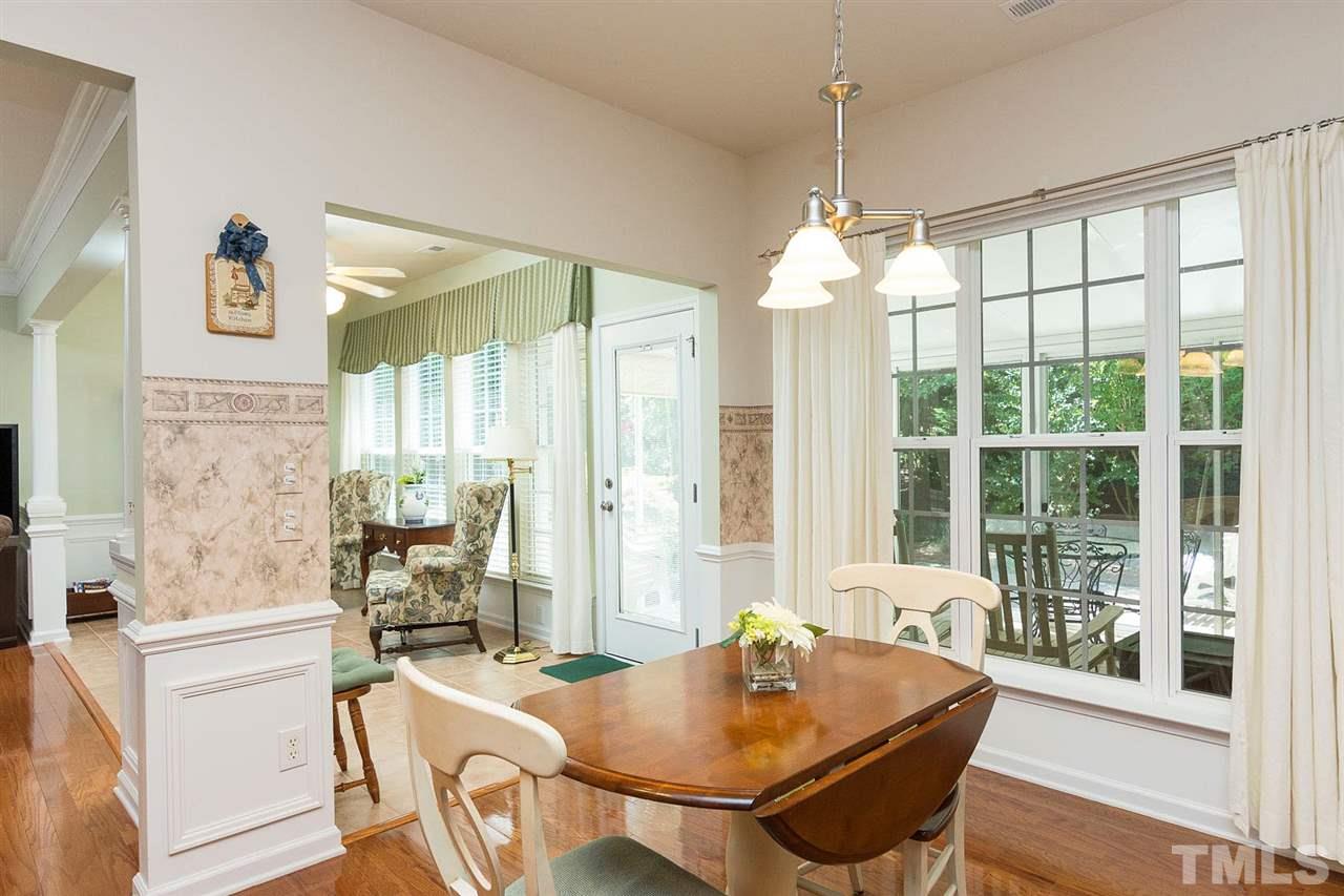 3413 Secretariat Way Raleigh, NC 27614 - Photo 8 of 23 a dining room with furniture a chandelier and wooden floor