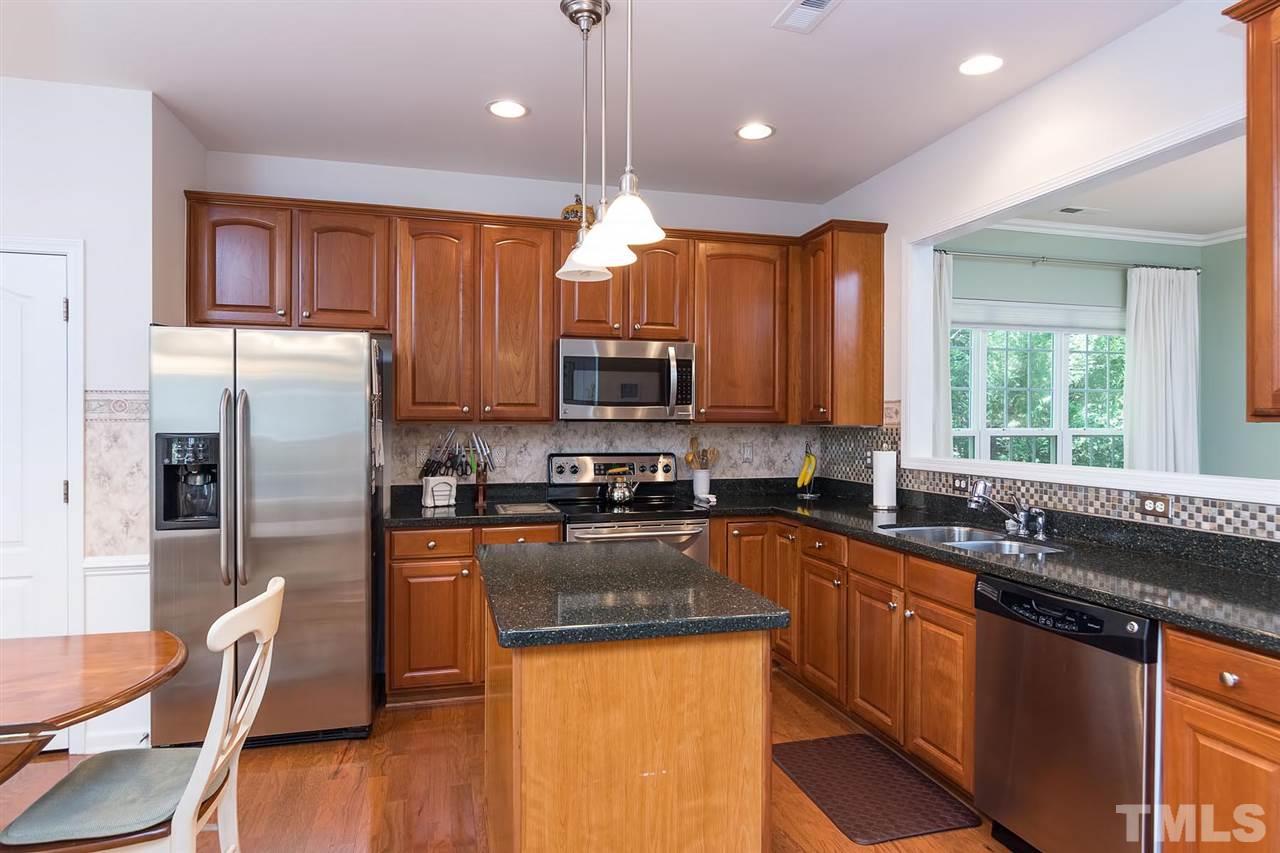 3413 Secretariat Way Raleigh, NC 27614 - Photo 9 of 23 a kitchen with stainless steel appliances granite countertop a sink refrigerator and microwave