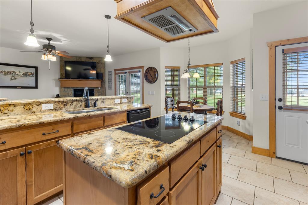 777 Stiles Road Whitesboro, TX 76273 - Photo 7 of 37 a kitchen with stainless steel appliances granite countertop a sink and a refrigerator