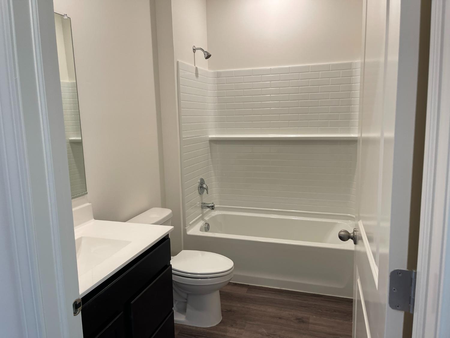 7754 West 103rd Street St. John, IN 46307 - Photo 24 of 39 a bathroom with a toilet and a tub