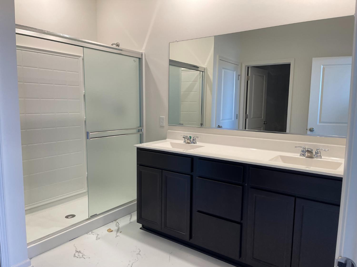 7754 West 103rd Street St. John, IN 46307 - Photo 31 of 39 a bathroom with a double vanity sink mirror and shower