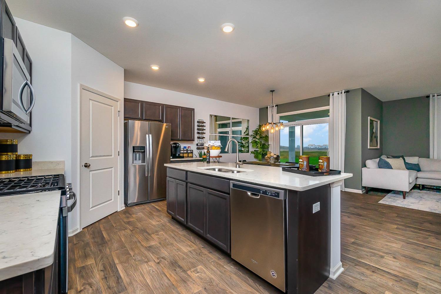 7754 West 103rd Street St. John, IN 46307 - Photo 8 of 39 a kitchen with kitchen island granite countertop a sink stove and refrigerator