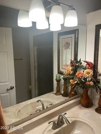 a bathroom with a sink a mirror and a vanity