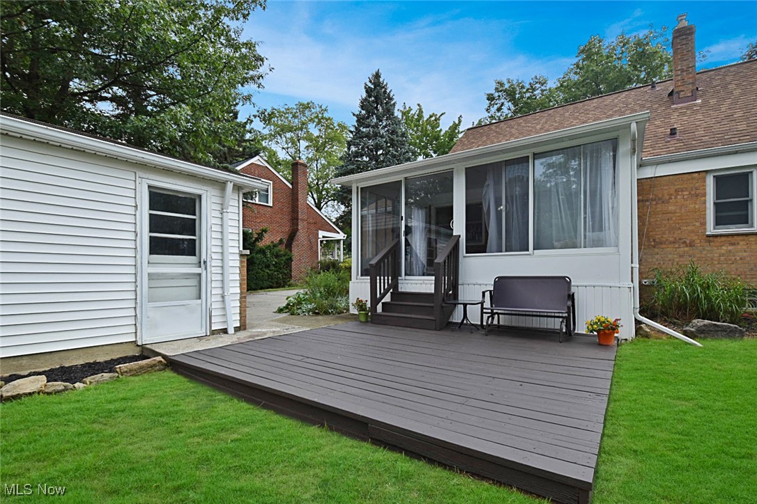 1388 Ford Road Lyndhurst, OH 44124 - Photo 35 of 39 Wooden deck featuring a sunroom and a lawn