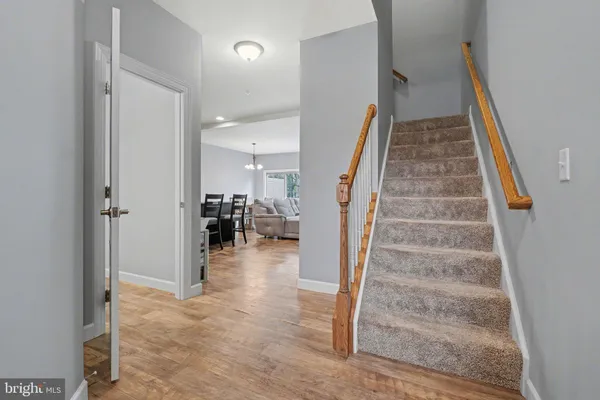 a view of a livingroom with wooden floor and stairs