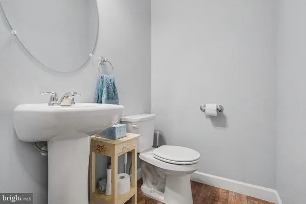 a bathroom with a sink mirror and toilet
