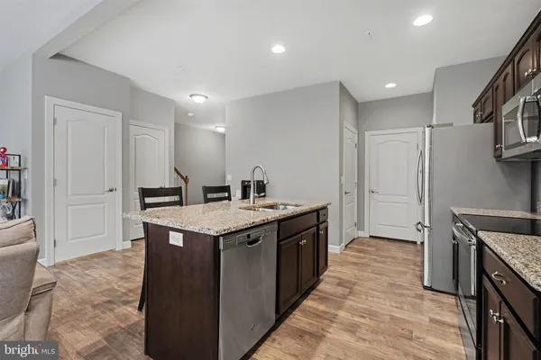 a kitchen with a sink and refrigerator