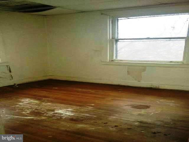 4920 Belair Road Baltimore, MD 21206 - Photo 13 of 16 a view of a room with wooden floor and a window