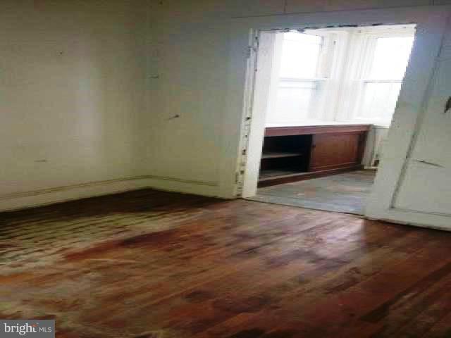 4920 Belair Road Baltimore, MD 21206 - Photo 16 of 16 a view of empty room with wooden floor and fan