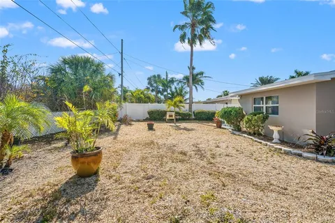 a view of a backyard with plants and a small yard