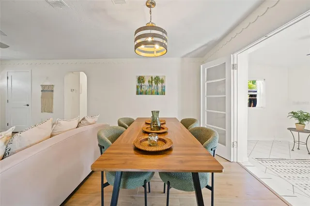 a view of a dining room with furniture and a potted plant