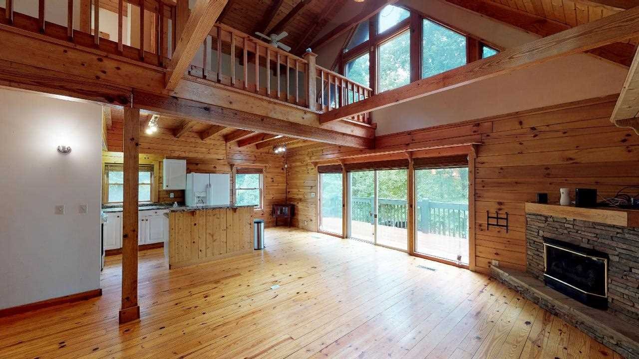 3095 Lower River Road Northwest Georgetown, TN 37336 - Photo 3 of 25 a view of a livingroom with furniture a fireplace window and wooden floor