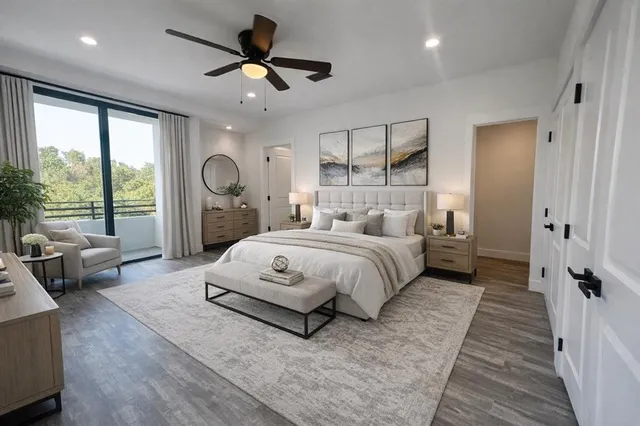 a bedroom with a large bed and a chandelier