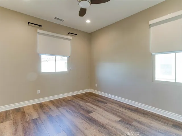 a view of an empty room and wooden floor