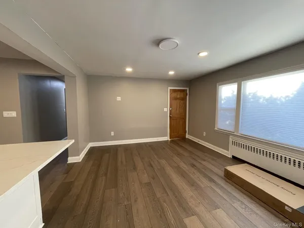 a view of a living room a stove and wooden floor