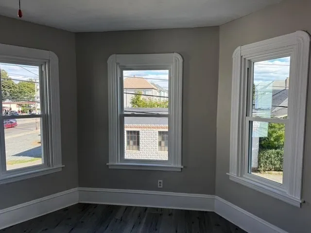 a small space with window and wooden floor