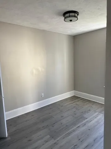 a view of an empty room and wooden floor